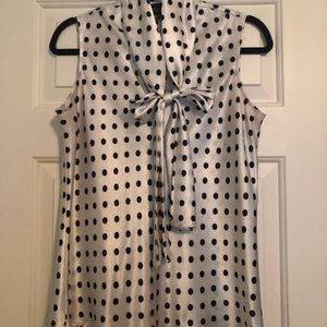 White blouse with black dots, tie in front